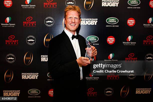 Hugh Vyvyan poses for a photo with his award having been inducted into the hall of fame during the Premiership Rugby Hall of Fame Dinner at...