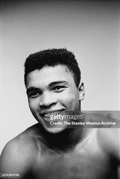 Cassius Clay smiles for the camera after he knocked out Archie Moore in the 4th round on November 15, 1962 in Los Angeles, California.