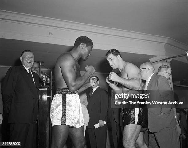 Ezzard Charles and Rocky Marciano face off after their weight-in before their bout for the world heavyweight championship at Yankee Stadium in New...