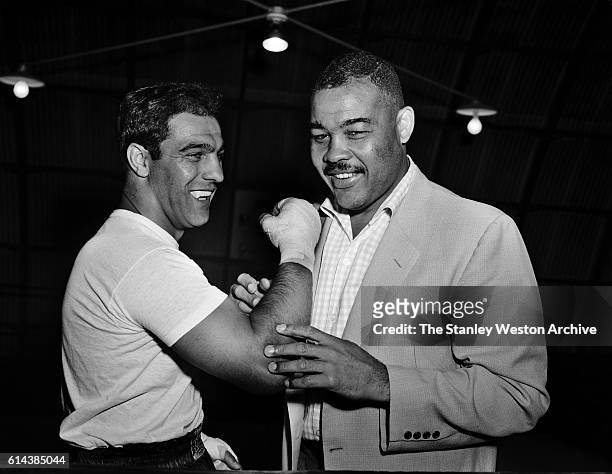 Rocky Marciano and Joe Louis talk boxing where Marciano is training for his title defense against Archie Moore at Grossingers, New York, September 1,...