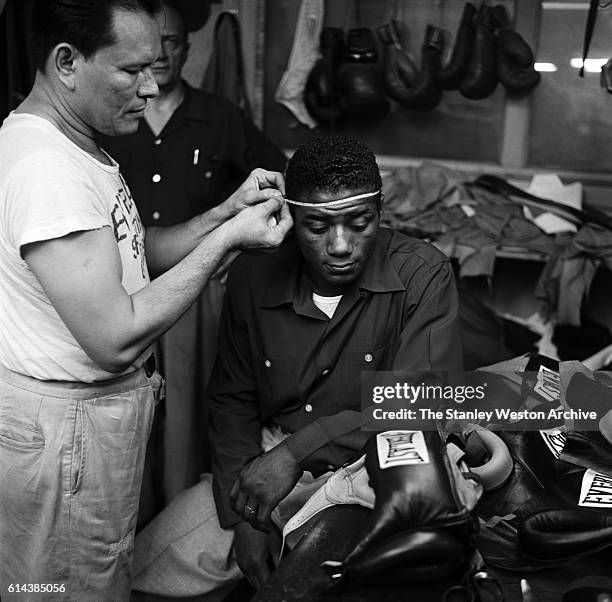 Floyd Patterson has his head measured for sparring gear at his training camp on May 12, 1956 at Greenwood Lake, New York.