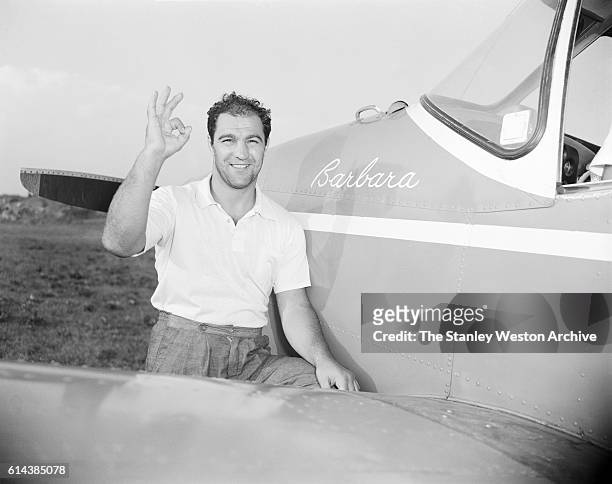 Rocky Marciano poses with his private airplane named after his wife Barbara during his time training for his title defense against Archie Moore at...