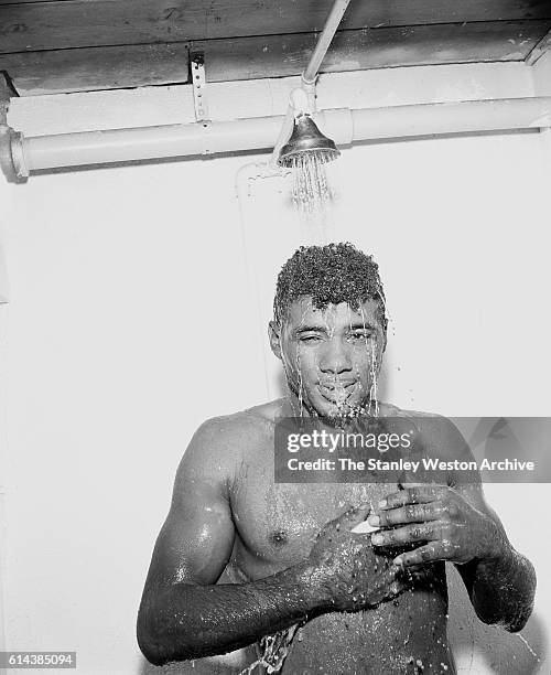 Floyd Patterson poses for the camera while taking a shower after training at his training camp on May 12, 1956 at Greenwood Lake, New York.
