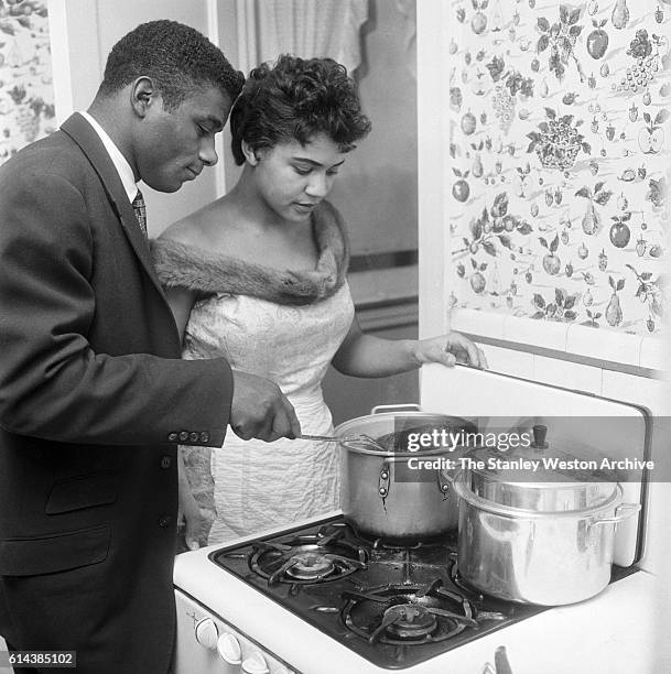 Floyd Patterson and his wife prepare a roast for dinner, circa 1961.