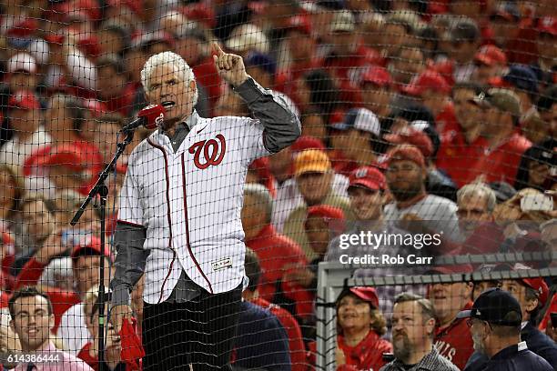 Former Washington Redskins player and Pro Football Hall of Fame member John Riggins yells "Play Ball" prior to game five of the National League...