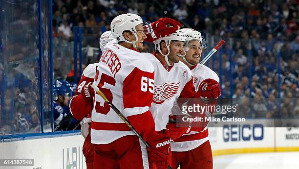 Thomas Vanek, center, is congratulated by Danny DeKeyser and Xavier Ouellet of the Detroit Red Wings after his second goal of the first period...