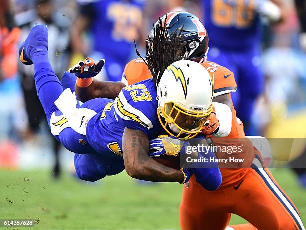 Dexter McCluster of the San Diego Chargers dives with the ball as he is tackle by Brandon Marshall of the Denver Broncos during the first quarter at...