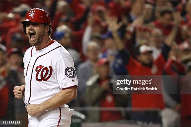 Daniel Murphy of the Washington Nationals celebrates after scoring off of an RBI single hit by Danny Espinosa of the Washington Nationals in the...