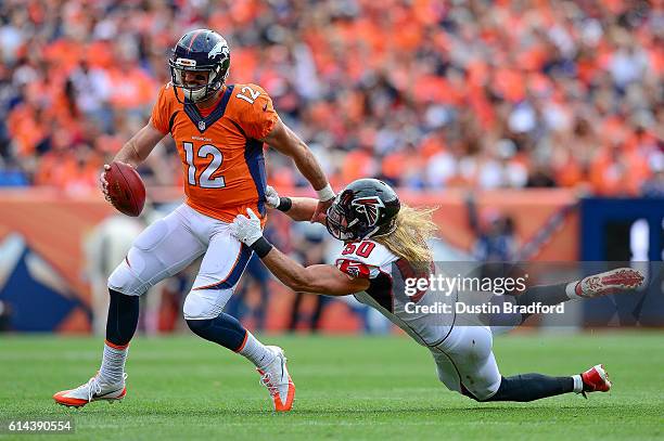 Linebacker A.J. Hawk of the Atlanta Falcons attempts to tackle quarterback Paxton Lynch of the Denver Broncos in the first half of the game at Sports...