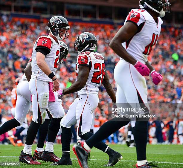 Running back Tevin Coleman of the Atlanta Falcons celebrates with Matt Ryan after scoring a touchdown in the third quarter of the game against the...