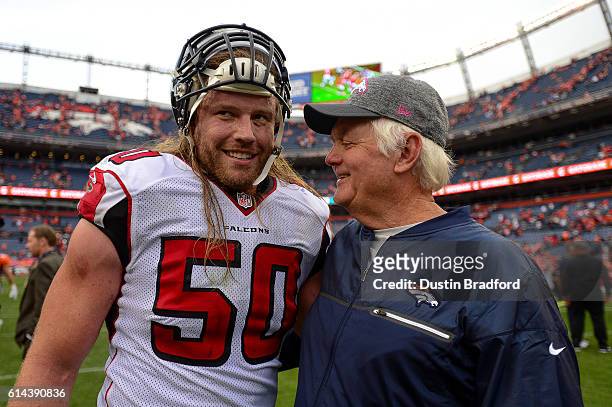 Defensive coordinator Wade Phillips of the Denver Broncos has a word with linebacker A.J. Hawk of the Atlanta Falcons after a game at Sports...
