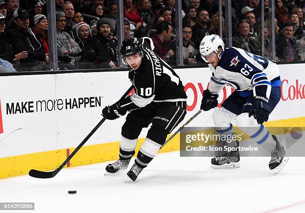 Los Angeles Kings Center Mike Richards [3483] maneuvers the puck around Winnipeg Jets Defenseman Ben Chiarot [7502] during an NHL game between the...