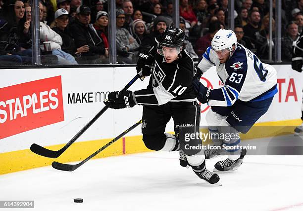 Los Angeles Kings Center Mike Richards [3483] maneuvers the puck around Winnipeg Jets Defenseman Ben Chiarot [7502] during an NHL game between the...