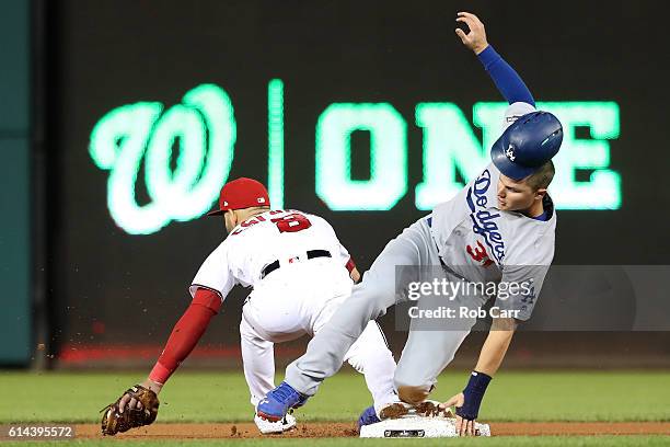 Joc Pederson of the Los Angeles Dodgers advances to second base against Danny Espinosa of the Washington Nationals in the fifth inning during game...