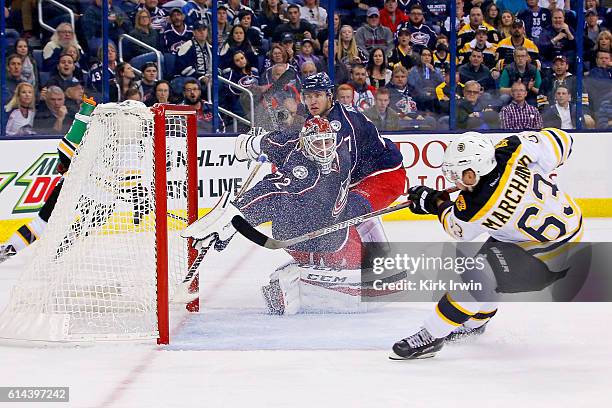 Brad Marchand of the Boston Bruins beats Sergei Bobrovsky of the Columbus Blue Jackets for the game-winning goal during the third period on October...