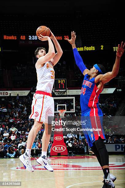 Ryan Kelly of the Atlanta Hawks shoots the ball against Tobias Harris of the Detroit Pistons on October 13, 2016 at Philips Arena in Atlanta,...