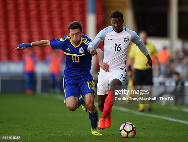 Demerai Gray of England is tackled by Armin Cerimagic of Bosnia and Herzegovina during the UEFA European U21 Championship qualifier match between...