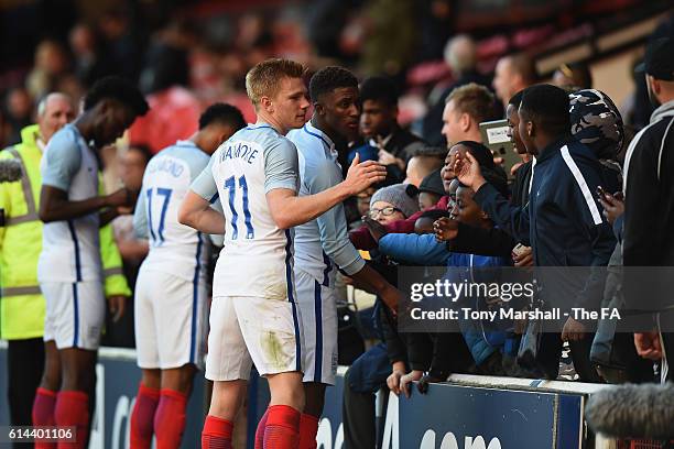 Duncan Watmore and Demerai Gray of England signs autographs for the fans after the UEFA European U21 Championship qualifier match between England and...