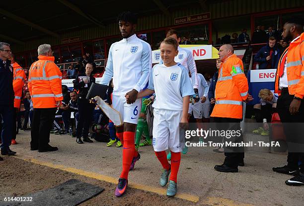 Nathaniel Chalobah of Englandleads out the team with the mascot during the UEFA European U21 Championship qualifier match between England and Bosnia...