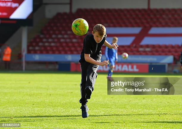 Young fans take part in a hit the crossbar competition at half time during the UEFA European U21 Championship qualifier match between England and...