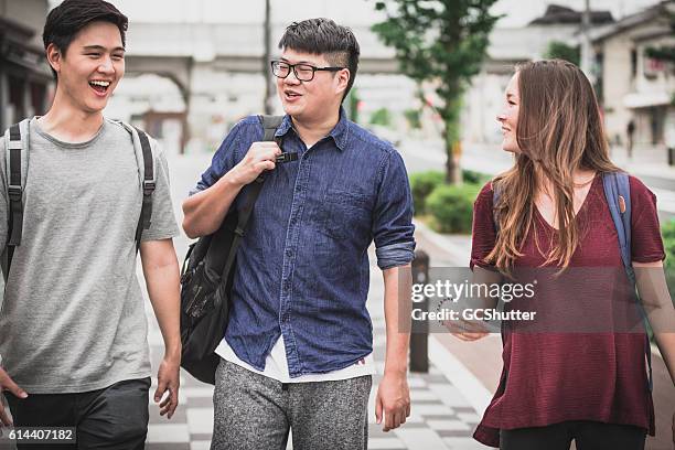 group of international students - heavy rucksack stock pictures, royalty-free photos & images