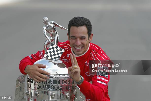 Marlboro Team Penske driver Helio Castroneves hugs the Borg-Warner Trophy at the official trophy presentation on the day after winning the 86th...