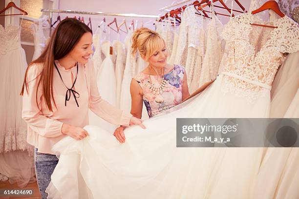 at bridal shop - wedding dress stock pictures, royalty-free photos & images