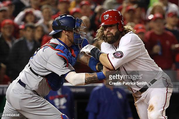 Jayson Werth of the Washington Nationals is tagged out for the third out of the sixth inning by Yasmani Grandal of the Los Angeles Dodgers during...
