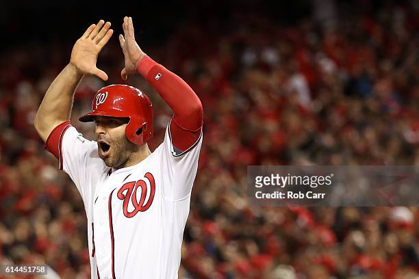 Danny Espinosa of the Washington Nationals celebrates after teammate Chris Heisey , hits a two run home run in the seventh inning against the Los...