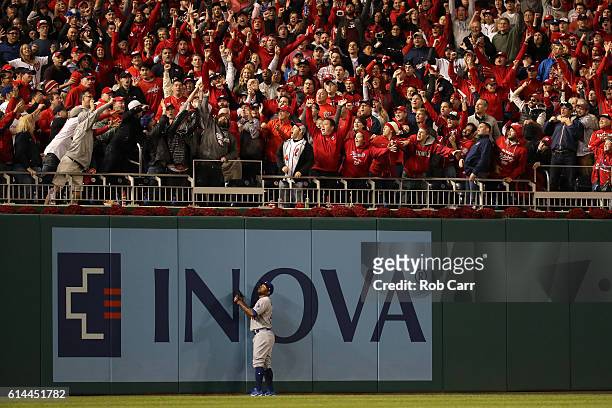 Howie Kendrick of the Los Angeles Dodgers watches a two run home run hit by Chris Heisey of the Washington Nationals in the seventh inning during...