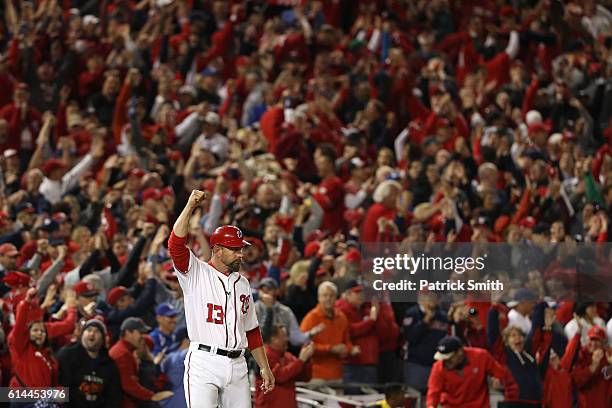 Third base coach Bob Henley of the Washington Nationals celebrates after Chris Heisey , hit a two run home run in the seventh inning against the Los...