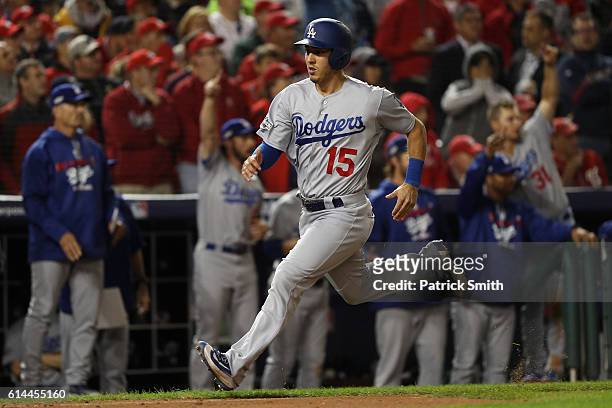 Austin Barnes of the Los Angeles Dodgers scores off of an RBI single hit by Carlos Ruiz in the seventh inning against the Washington Nationals during...