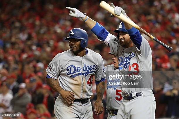 Howie Kendrick and Adrian Gonzalez of the Los Angeles Dodgers celebrate after teammate Justin Turner hit a two run RBI triple in the seventh inning...