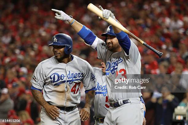 Howie Kendrick and Adrian Gonzalez of the Los Angeles Dodgers celebrate after teammate Justin Turner hit a two run RBI triple in the seventh inning...