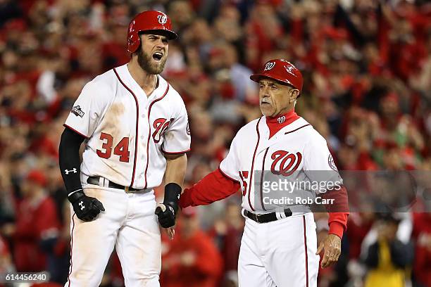 Bryce Harper of the Washington Nationals reacts after hitting a single against the Los Angeles Dodgers in the seventh inning during game five of the...