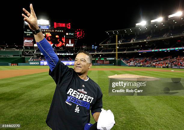 Manager Dave Roberts of the Los Angeles Dodgers celebrates after winning game five of the National League Division Series over the Washington...