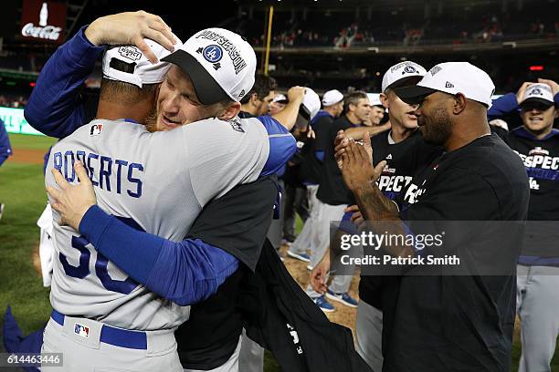 Manager Dave Roberts of the Los Angeles Dodgers celebrates with his team after winning game five of the National League Division Series over the...