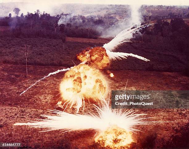 View of fireballs from ignited napalm dropped on suspected Viet Cong targets, South Vietnam, 1966.