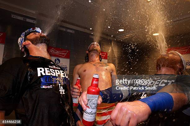 Adrian Gonzalez, Josh Reddick and Justin Turner of the Los Angeles Dodgers celebrate in the clubhouse after winning game five of the National League...