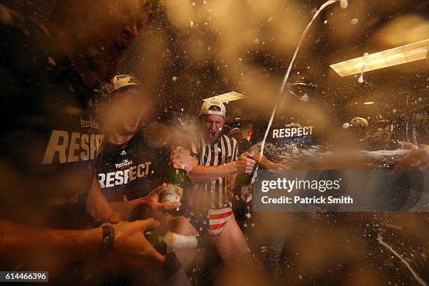 Josh Reddick of the Los Angeles Dodgers celebrates with teammates in the clubhouse after winning game five of the National League Division Series...