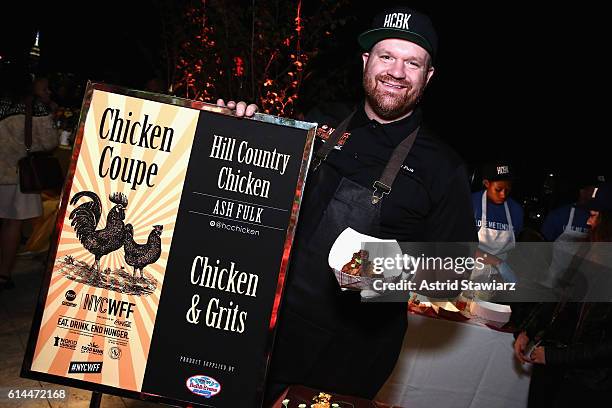 Chef Ash Fulk poses with his Chicken and Grits at Chicken Coupe hosted by Whoopi Goldberg and Andrew Carmellini at The William Vale on October 13,...