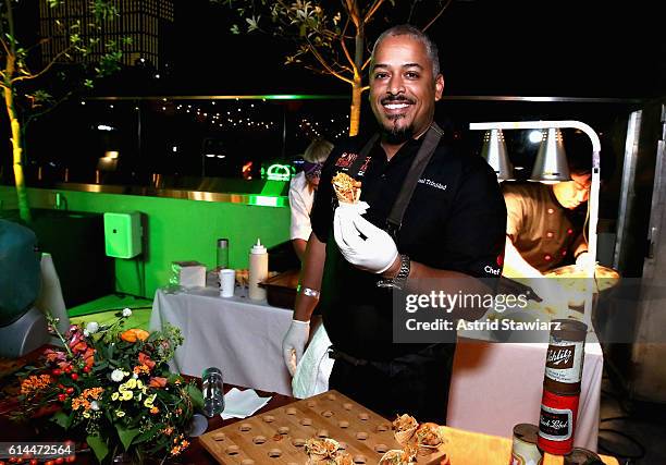 Chef Miguel Trinidad poses with his Popcorn BBQ Chicken Waffle Cone at Chicken Coupe hosted by Whoopi Goldberg and Andrew Carmellini at The William...