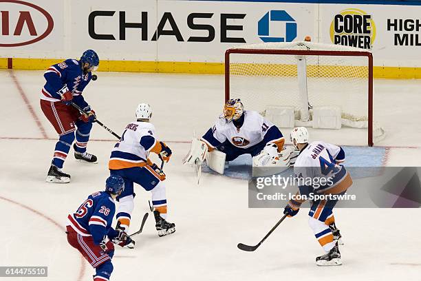 New York Rangers Left Wing Rick Nash tries to regain control of he puck in front of New York Islanders Goalie Jaroslav Halak during the second period...
