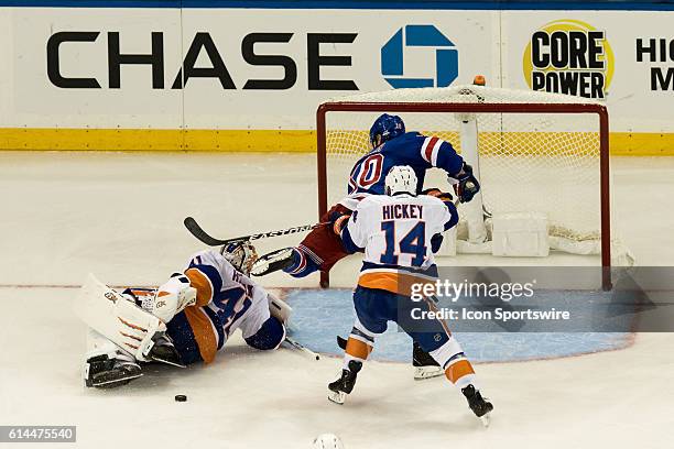 New York Islanders Goalie Jaroslav Halak blocks a shot by a charging New York Rangers Center J.T. Miller during the second period of opening night at...