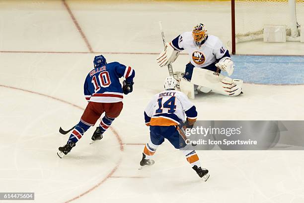 New York Rangers Center J.T. Miller works the puck towards New York Islanders Goalie Jaroslav Halak during the second period of opening night at...