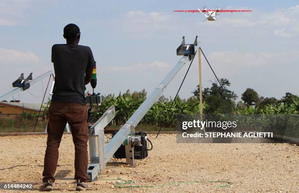 Technician of California-based robotics company Zipline launches a drone, on October 12, 2016 in Muhanga, 50 kilometres west of the capital Kigali. -...