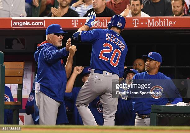 Chicago Cubs Outfield Matt Szczur [9144] is congratulated by manager Joe Maddon after hitting a home run during an MLB game between the Chicago Cubs...