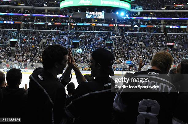 Fans celebrate in the final minute of the game during game 6 of the first round of the Stanley Cup Playoffs between the San Jose Sharks and the Los...