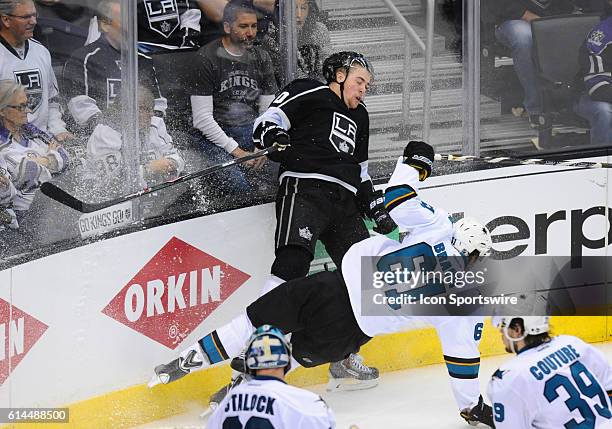 Kings Tanner Pearson is shoved into the boards by Sharks Justin Braun during game 6 of the first round of the Stanley Cup Playoffs between the San...