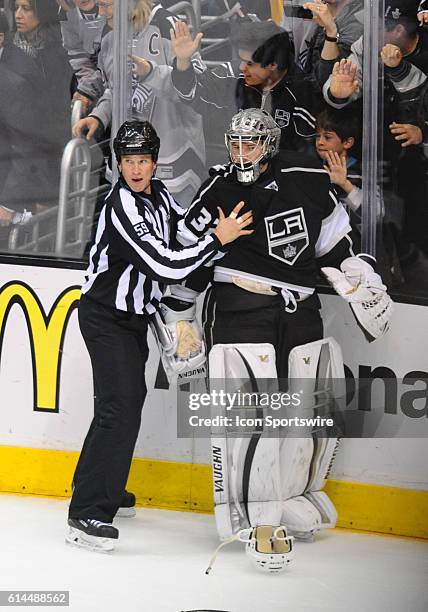 Kings Jonathan Quick is pushed away from the large brawl late in the third period during game 6 of the first round of the Stanley Cup Playoffs...
